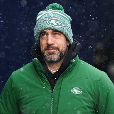 Aaron Rodgers of the Jets runs onto the field.