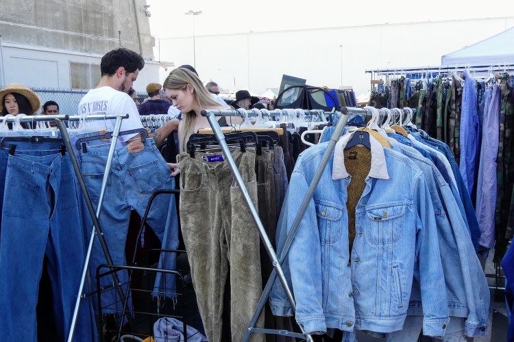 denim on racks, woman looking through